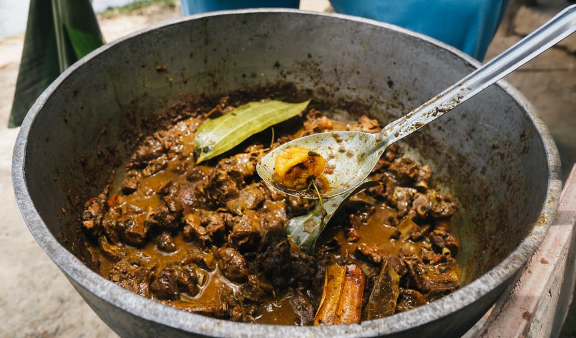 Food cooking in a large pot outdoors