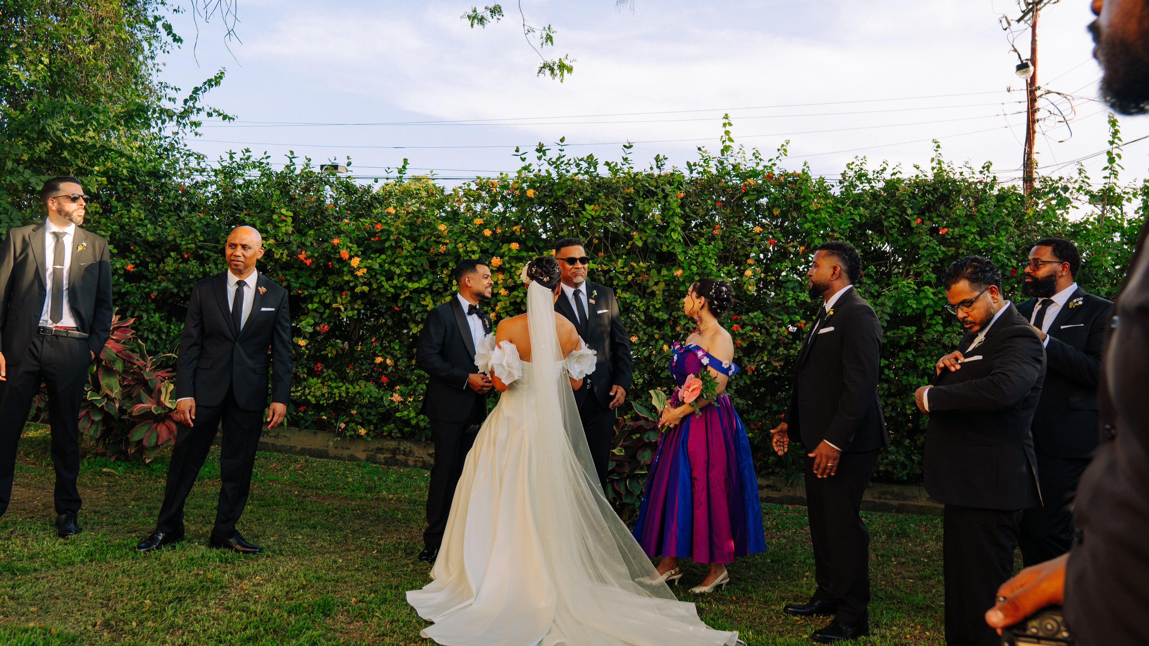 Kevin and Alix standing with members of their wedding party