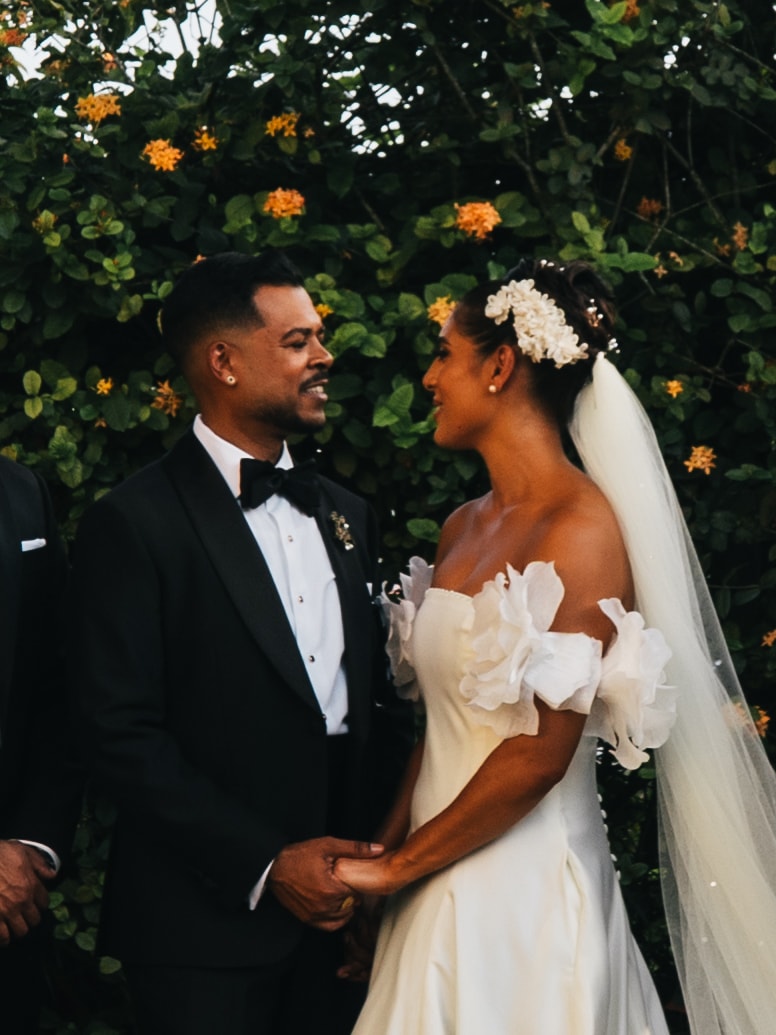 Kevin and Alix holding hands and smiling at each other